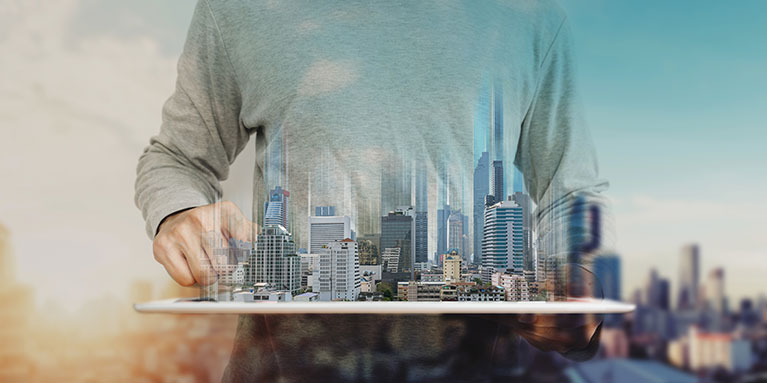 A man holding a model of a metropolitan city in his hands.